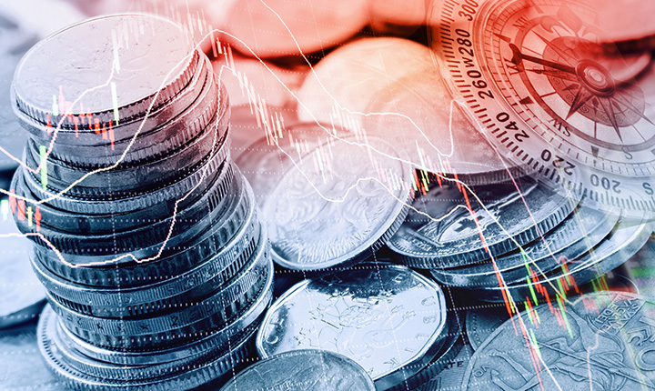 Stacked coins with digital overlay of charts